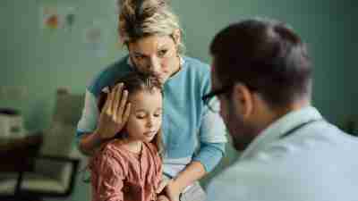 A mother attends a doctor's appointment with her child, who is showing signs of ADHD.